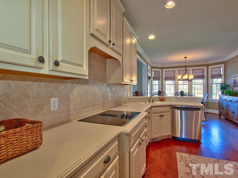 224 Waterville Street Raleigh, NC 27603 - Photo 7 of 25 a kitchen that has a sink a stove and cabinets