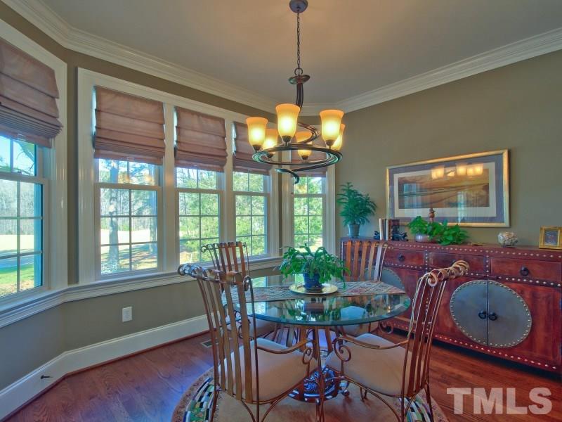 224 Waterville Street Raleigh, NC 27603 - Photo 8 of 25 a dining room with furniture a window and a chandelier