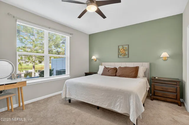 a bathroom with a toilet sink double vanity and mirror