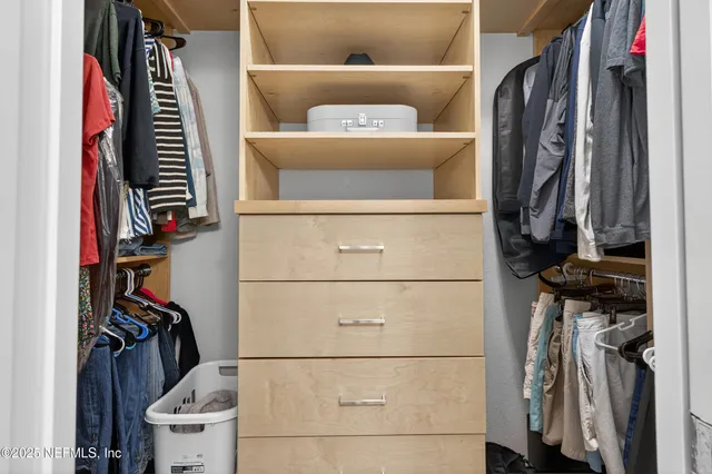 a front view of a house with a garden and mountain view