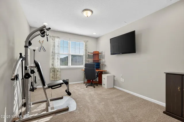 an aerial view of a house with garden space and a patio