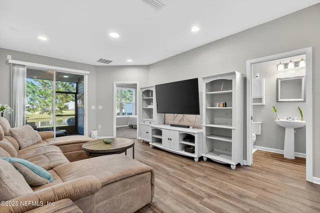 a kitchen with a dining table chairs and refrigerator
