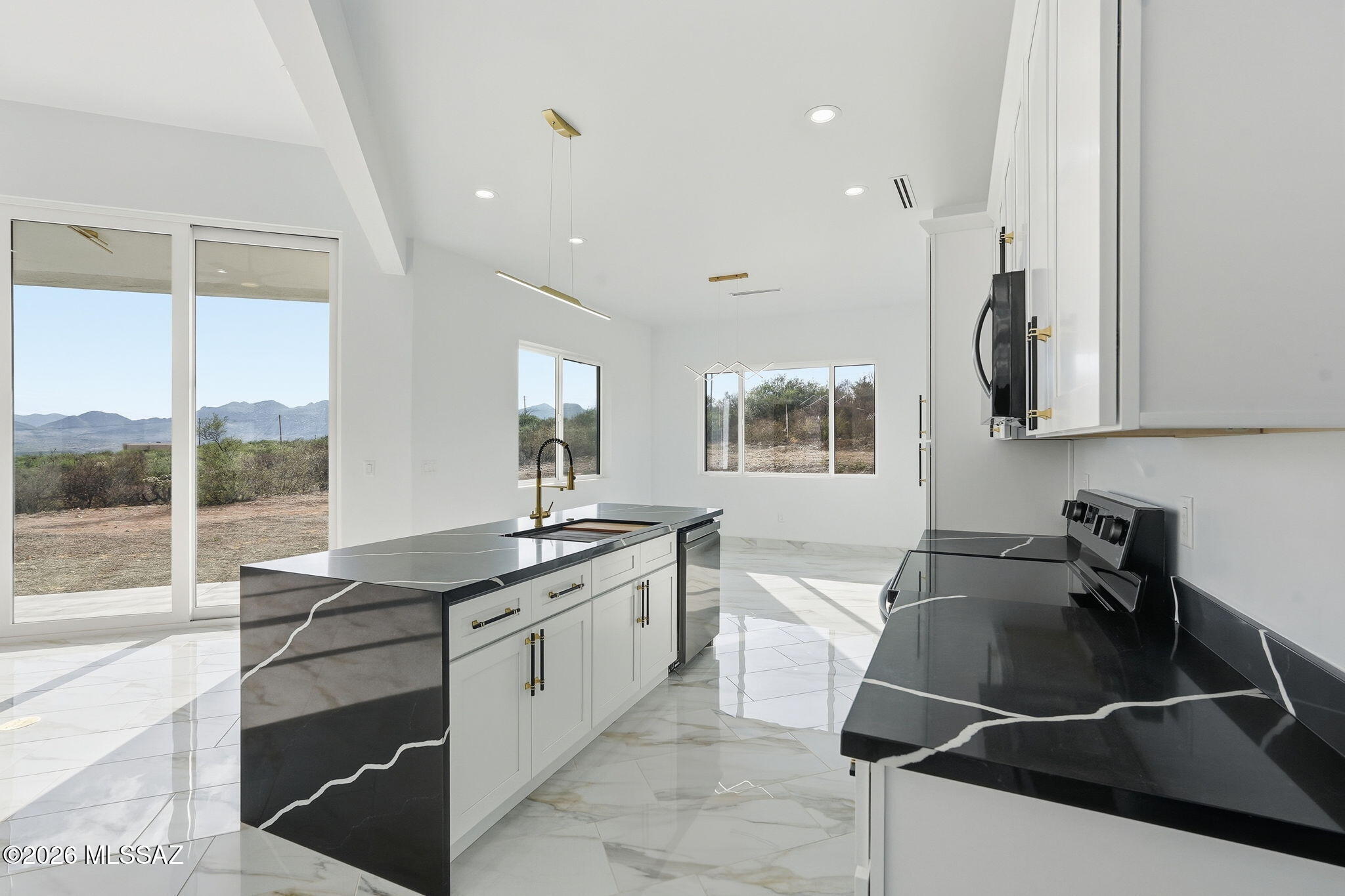 1786 Peralta Court Rio Rico, AZ 85648 - Photo 13 of 50 a kitchen that has a sink and a stove