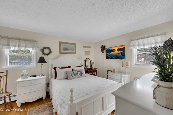 a bedroom with furniture and a flat screen tv