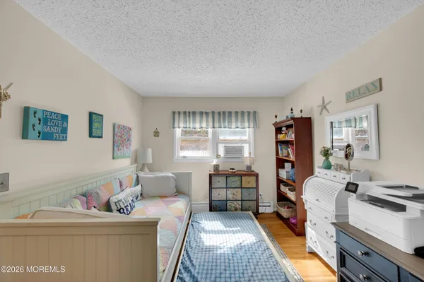 a bedroom with furniture and a book shelf
