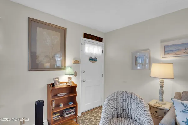 a bedroom with furniture and a mirror