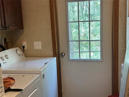 a kitchen with a refrigerator and a stove