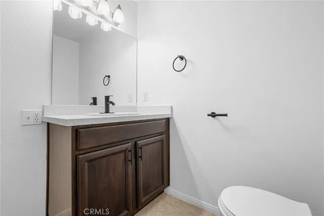 a bathroom with a sink vanity mirror and toilet