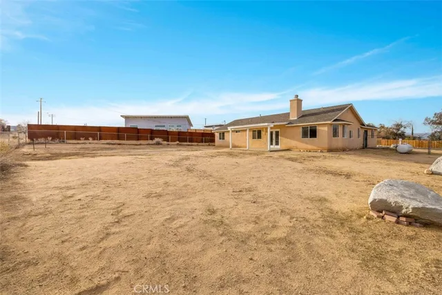 a view of a house with yard and sitting area