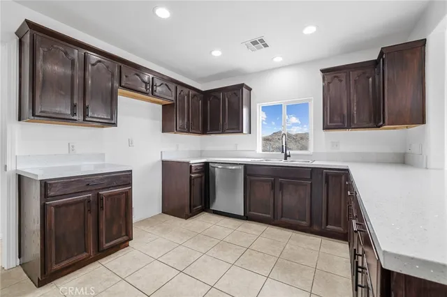 a kitchen with a sink stove top oven and cabinets