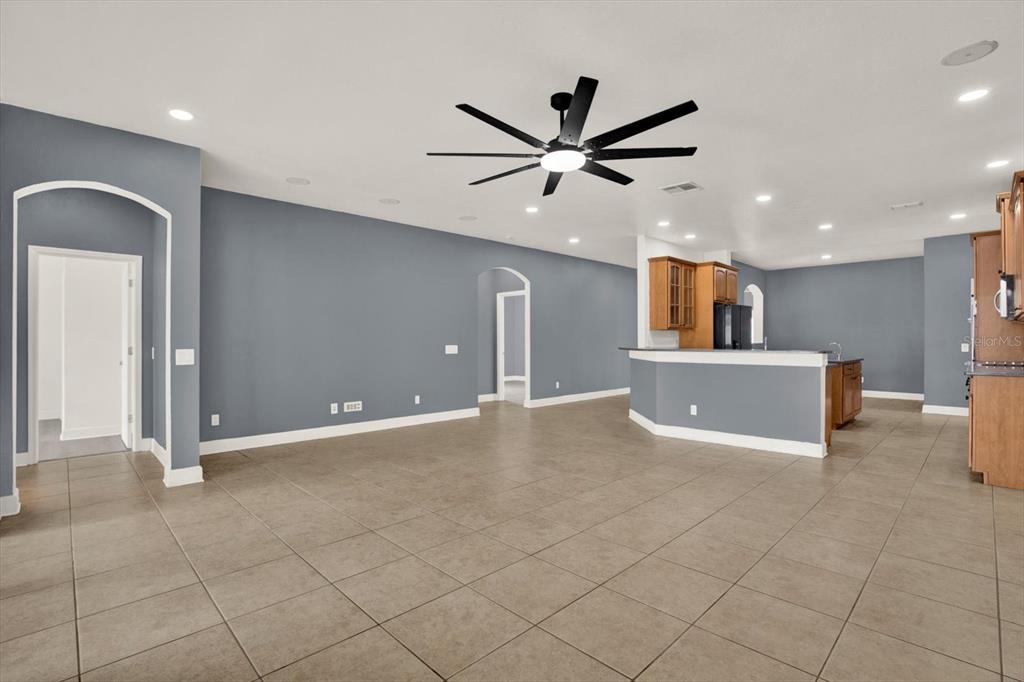 13397 Hunters Point Street Spring Hill, FL 34609 - Photo 12 of 38 a view of a livingroom with a furniture and a ceiling fan