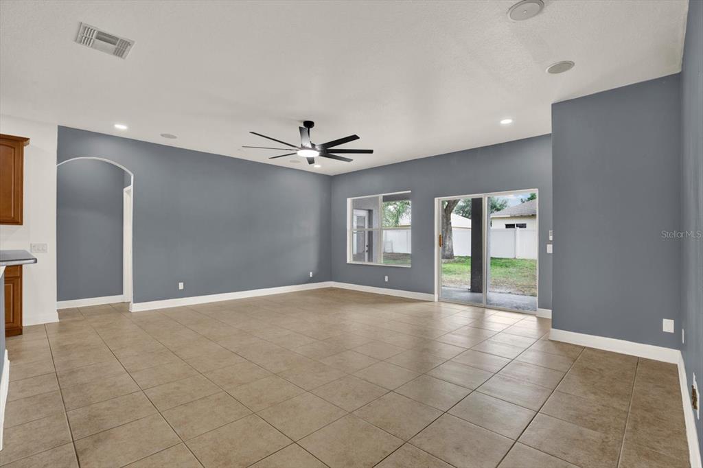 13397 Hunters Point Street Spring Hill, FL 34609 - Photo 13 of 38 a view of an empty room with glass door