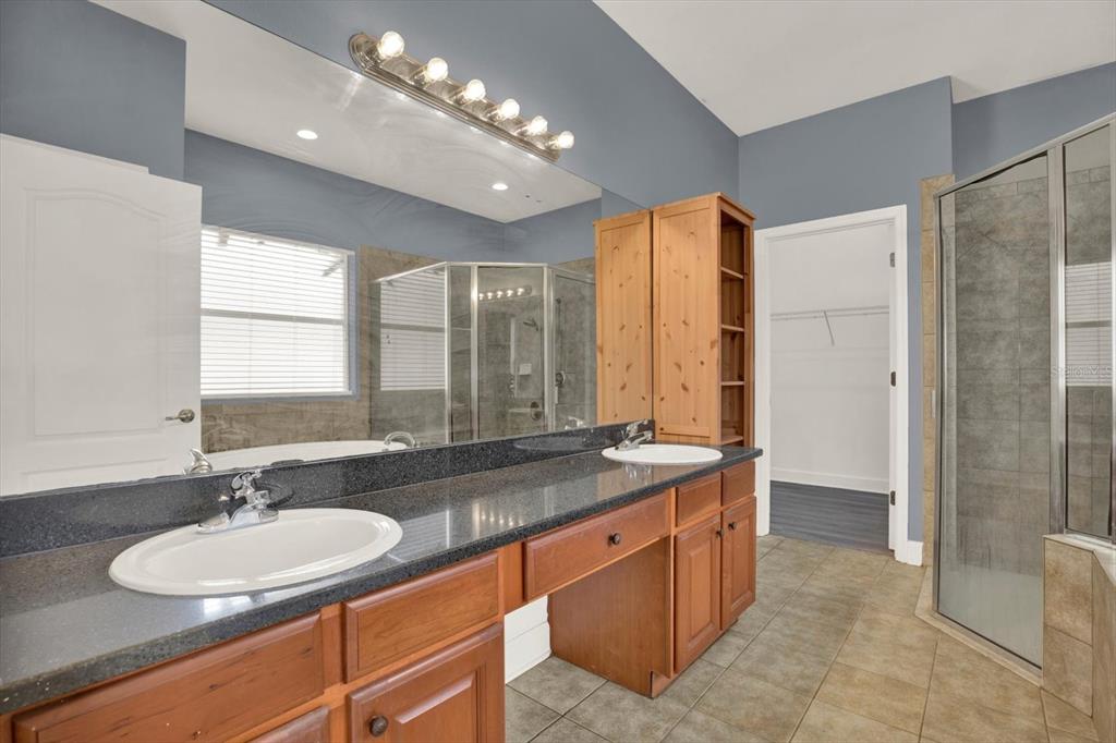 13397 Hunters Point Street Spring Hill, FL 34609 - Photo 17 of 38 a bathroom with a double vanity sink and a mirror