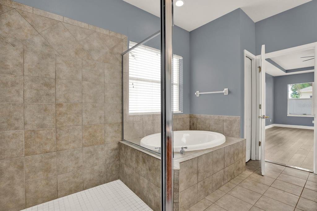 13397 Hunters Point Street Spring Hill, FL 34609 - Photo 18 of 38 a bathroom with a sink and a mirror