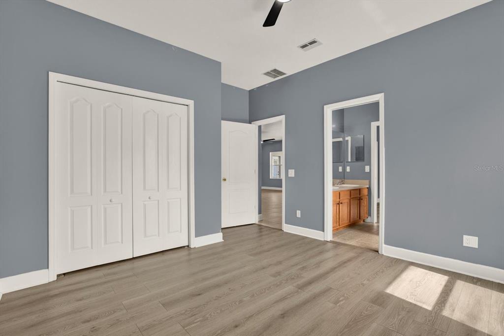 13397 Hunters Point Street Spring Hill, FL 34609 - Photo 21 of 38 wooden floor in an empty room