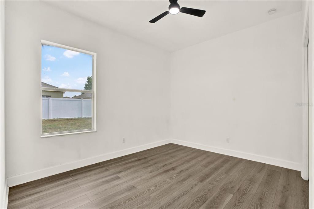 13397 Hunters Point Street Spring Hill, FL 34609 - Photo 27 of 38 an empty room with a window