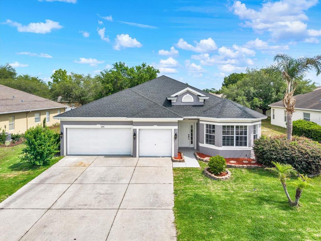 13397 Hunters Point Street Spring Hill, FL 34609 - Photo 29 of 38 front view of house with a yard