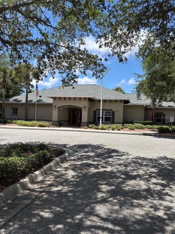 13397 Hunters Point Street Spring Hill, FL 34609 - Photo 36 of 38 a front view of a house with a garden
