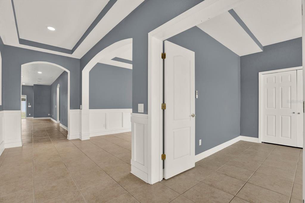 13397 Hunters Point Street Spring Hill, FL 34609 - Photo 6 of 38 a view of a hallway with wooden floor and entryway
