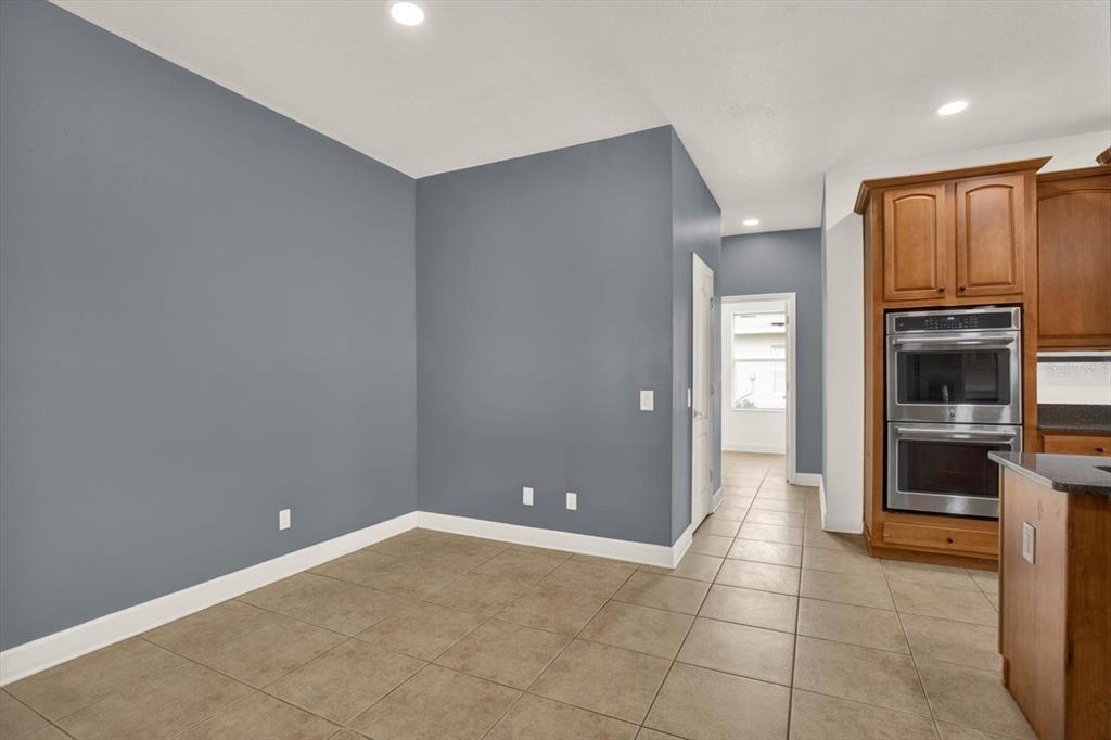 13397 Hunters Point Street Spring Hill, FL 34609 - Photo 9 of 38 a view of an empty room with kitchen and a window
