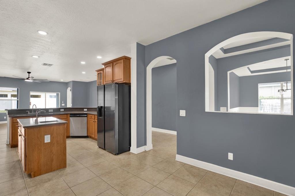 13397 Hunters Point Street Spring Hill, FL 34609 - Photo 10 of 38 a kitchen with stainless steel appliances granite countertop a refrigerator and a sink