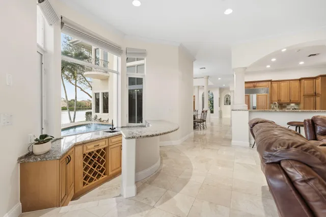 a bathroom with a granite countertop toilet sink and mirror