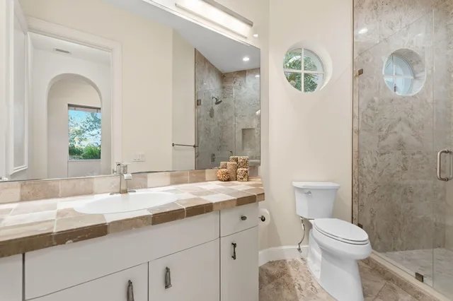 a bathroom with a toilet and a shower
