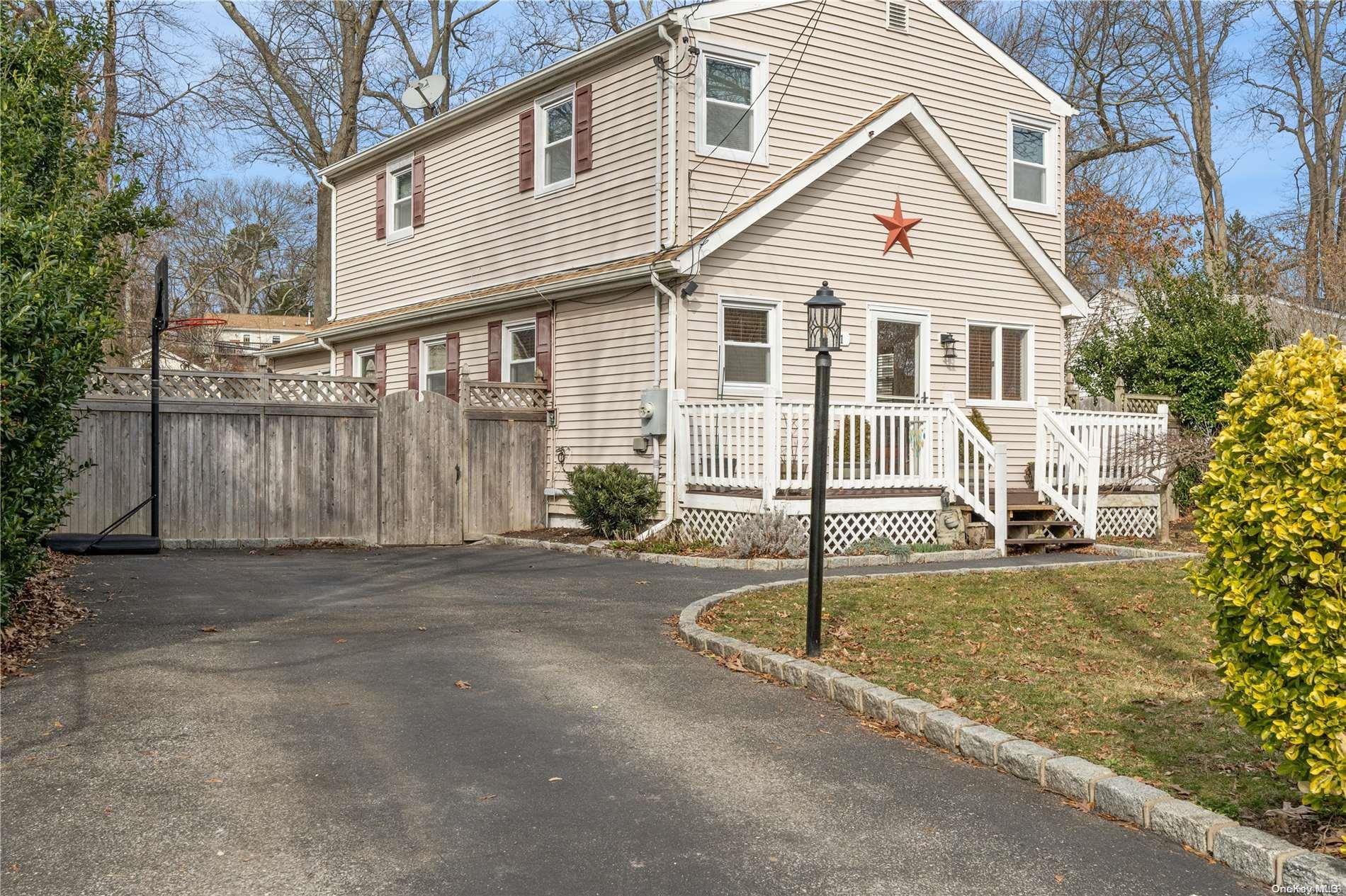 61 Freya Road Rocky Point, NY 11778 - Photo 1 of 1 a front view of a house with a yard garage and outdoor seating