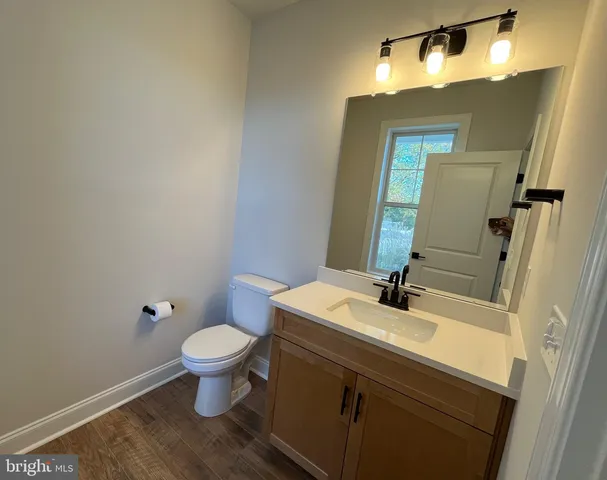 a bathroom with a sink toilet and mirror