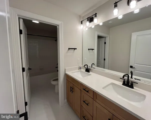 an empty room with a fireplace and windows