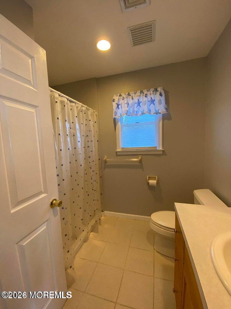 564 Perch Avenue Manasquan, NJ 08736 - Photo 15 of 15 a bathroom with a sink a toilet and shower