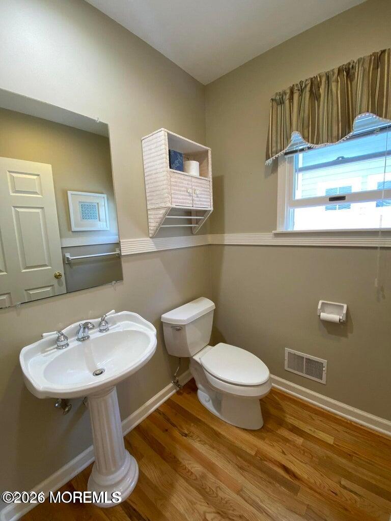 564 Perch Avenue Manasquan, NJ 08736 - Photo 8 of 15 a bathroom with a sink a toilet and a mirror