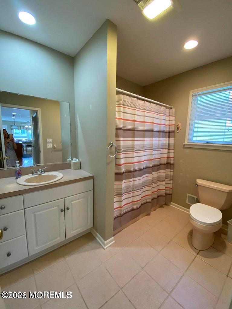 564 Perch Avenue Manasquan, NJ 08736 - Photo 9 of 15 a bathroom with a toilet sink and mirror