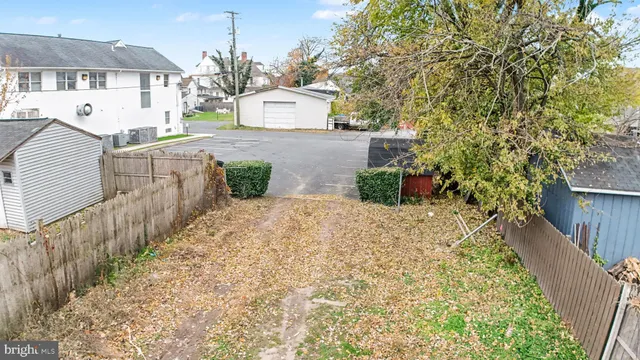 a view of a house with wooden fence