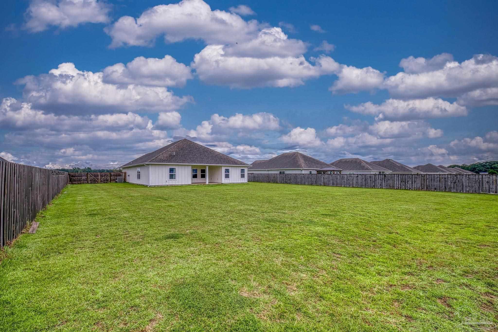2635 Ten Mile Road Pace, FL 32571 - Photo 54 of 67 a view of a house with a big yard and a large tree