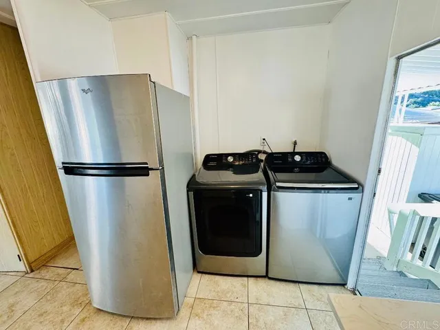 a utility room with wooden floor washer and dryer