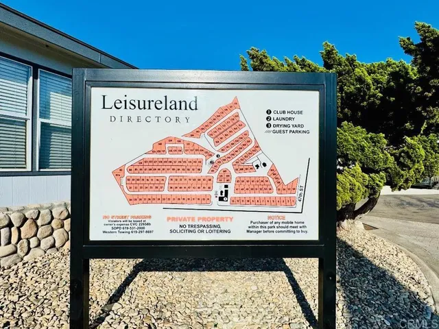 a front view of a house with a tree