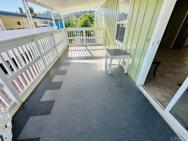 a view of balcony with wooden floor
