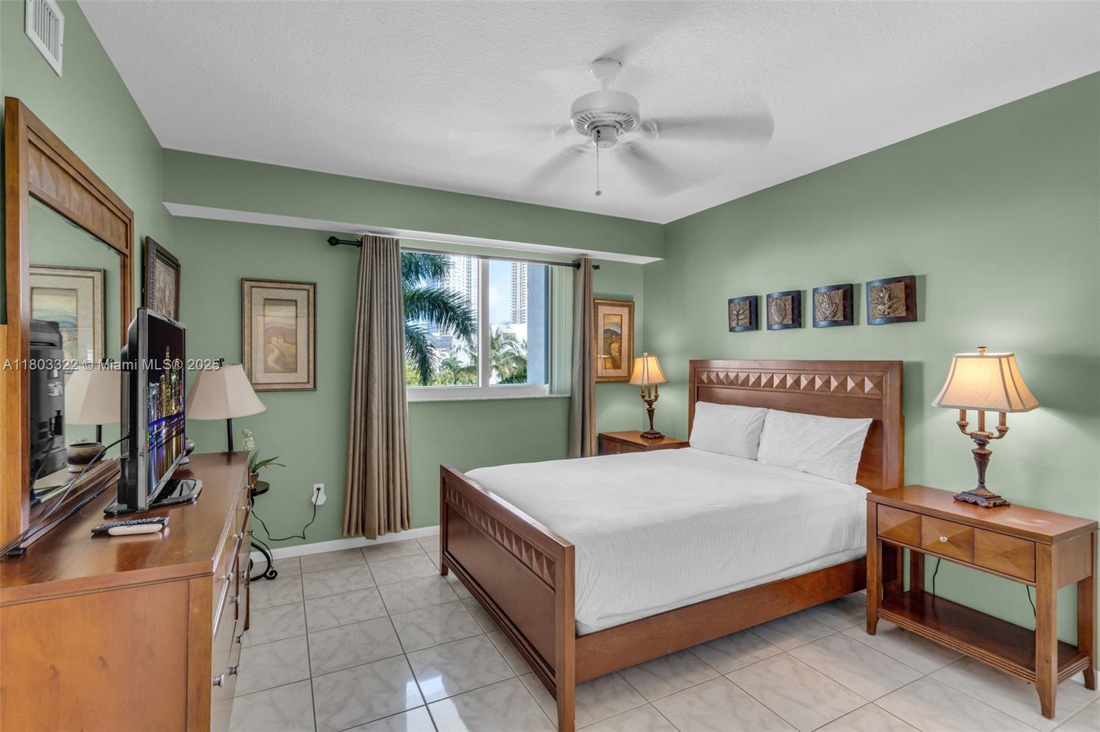 18100 North Bay Road, Unit 404 Sunny Isles Beach, FL 33160 - Photo 12 of 34 a bedroom with a bed and a chandelier