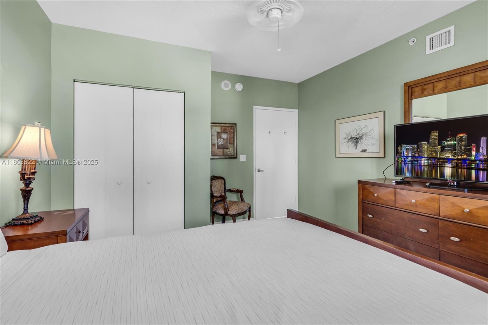 18100 North Bay Road, Unit 404 Sunny Isles Beach, FL 33160 - Photo 13 of 34 a bed room with a bed and a dresser