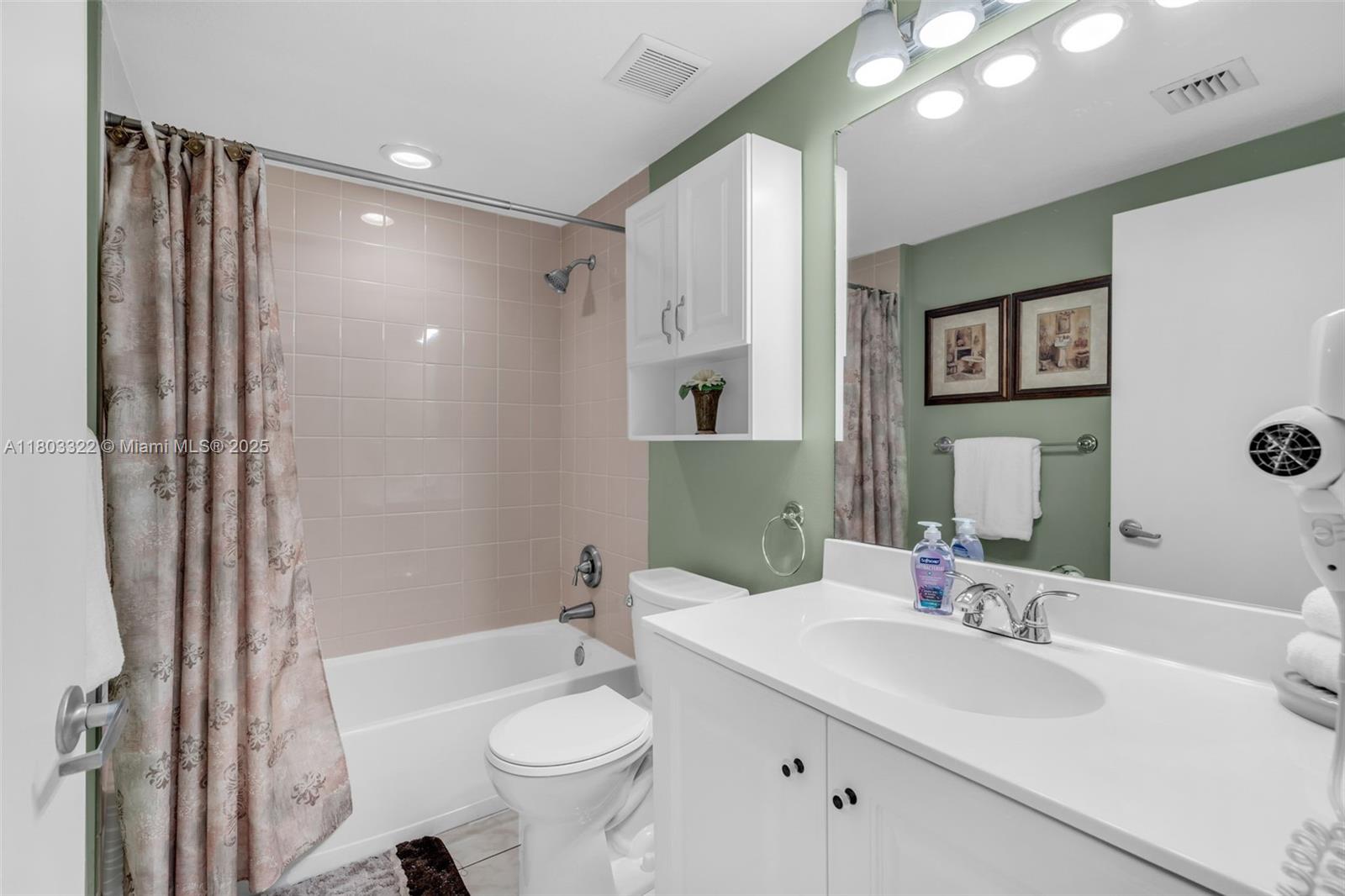 18100 North Bay Road, Unit 404 Sunny Isles Beach, FL 33160 - Photo 14 of 34 a bathroom with a sink toilet and shower