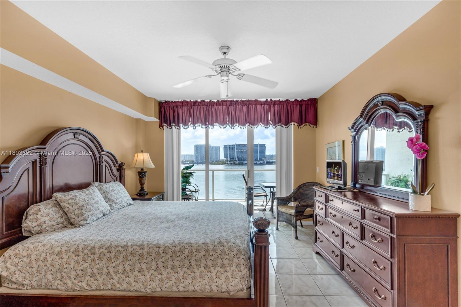 18100 North Bay Road, Unit 404 Sunny Isles Beach, FL 33160 - Photo 15 of 34 a bedroom with a large bed and wooden floor