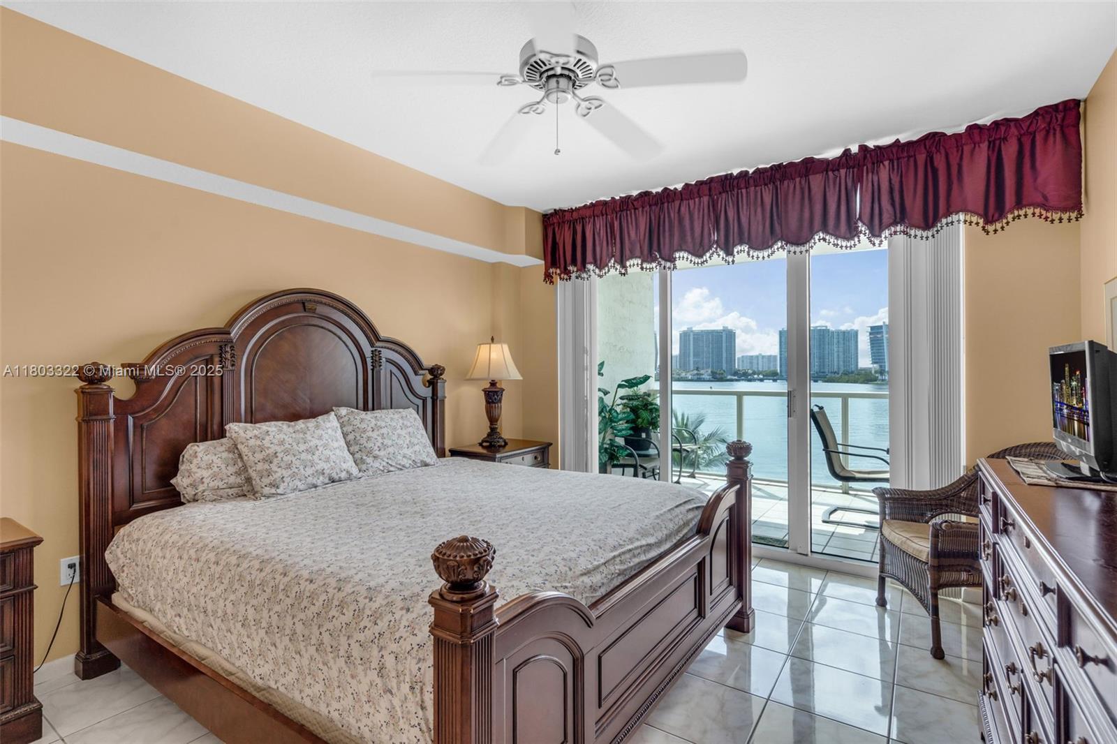 18100 North Bay Road, Unit 404 Sunny Isles Beach, FL 33160 - Photo 16 of 34 a bedroom with a bed and a large window