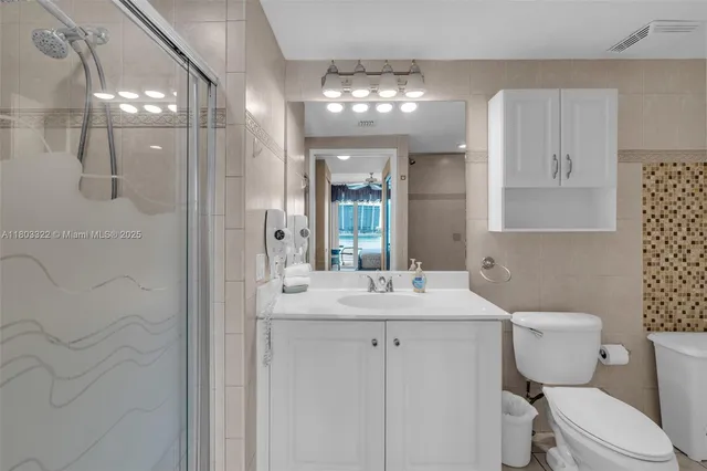 a bathroom with a sink toilet and shower