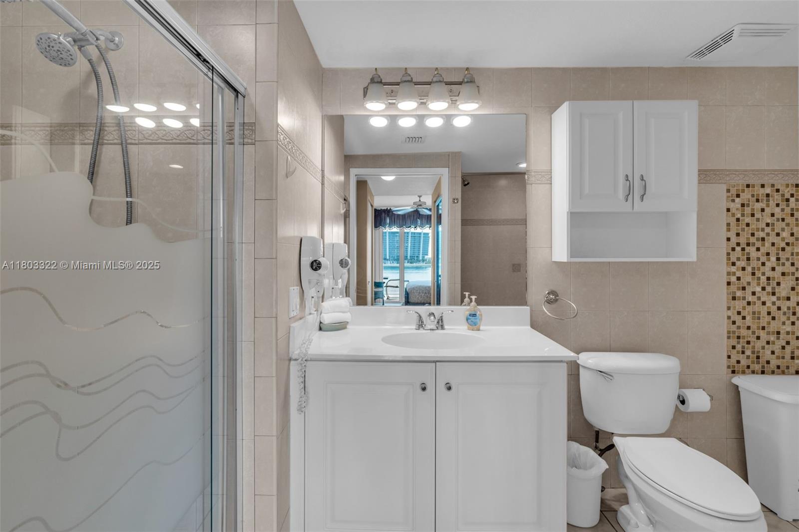 18100 North Bay Road, Unit 404 Sunny Isles Beach, FL 33160 - Photo 18 of 34 a bathroom with a sink toilet and shower