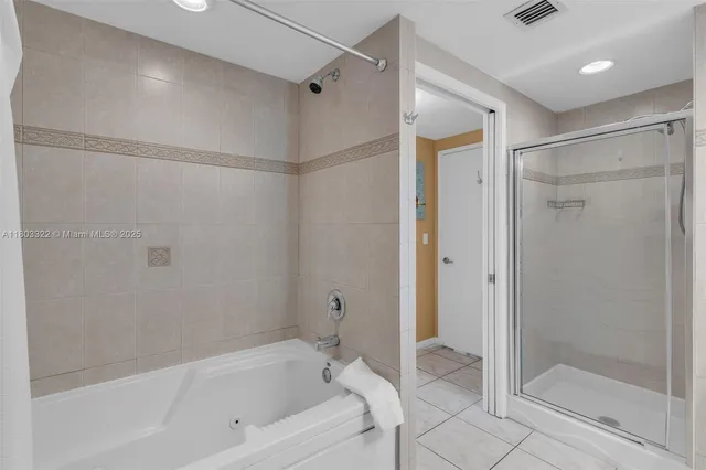 a bathroom with a bathtub and a shower