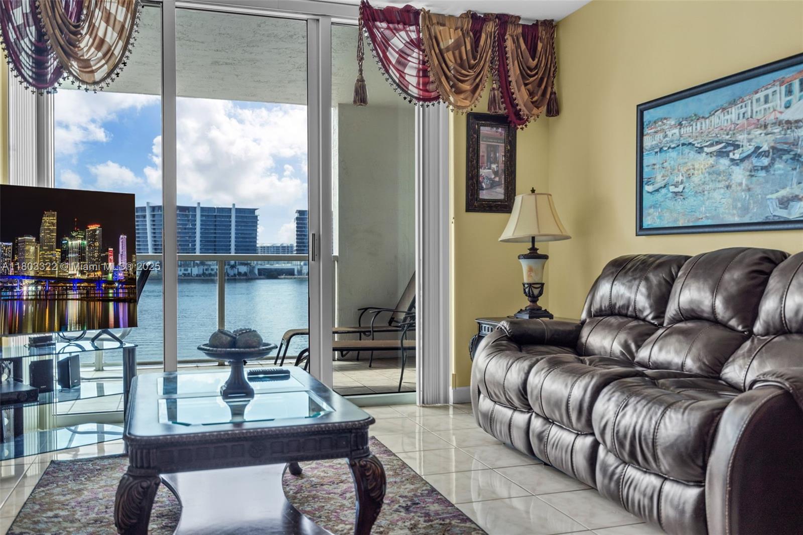 18100 North Bay Road, Unit 404 Sunny Isles Beach, FL 33160 - Photo 20 of 34 a living room with furniture and a book shelf