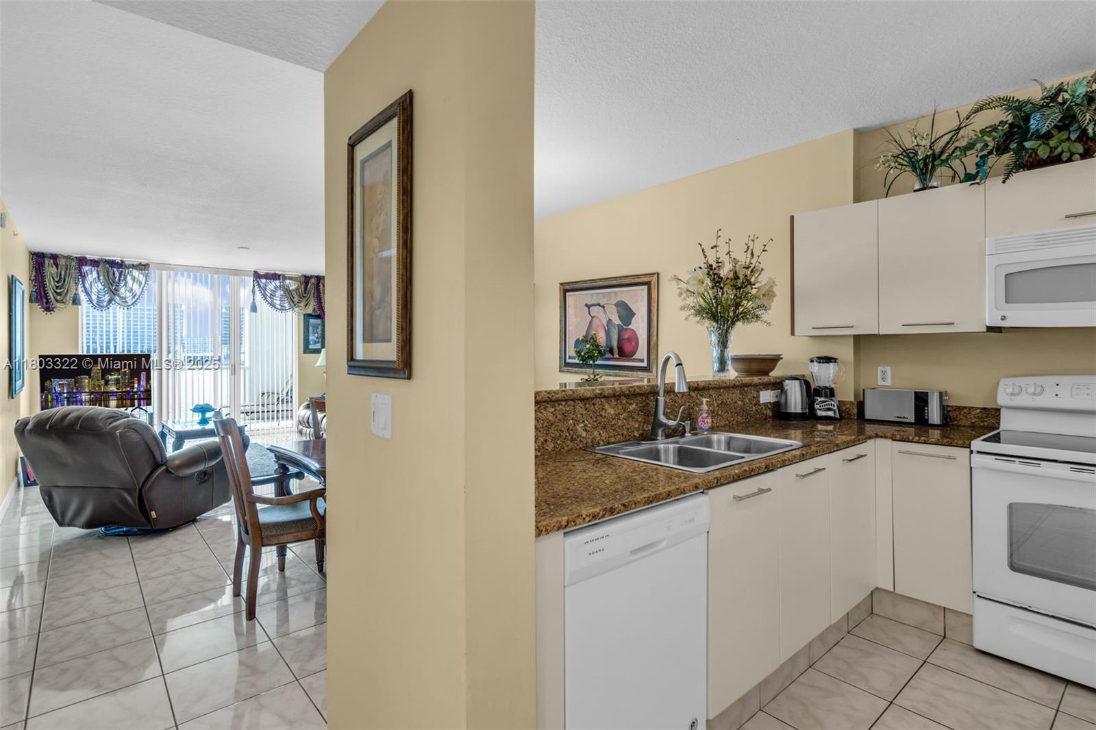 18100 North Bay Road, Unit 404 Sunny Isles Beach, FL 33160 - Photo 4 of 34 a kitchen with a sink cabinets and window