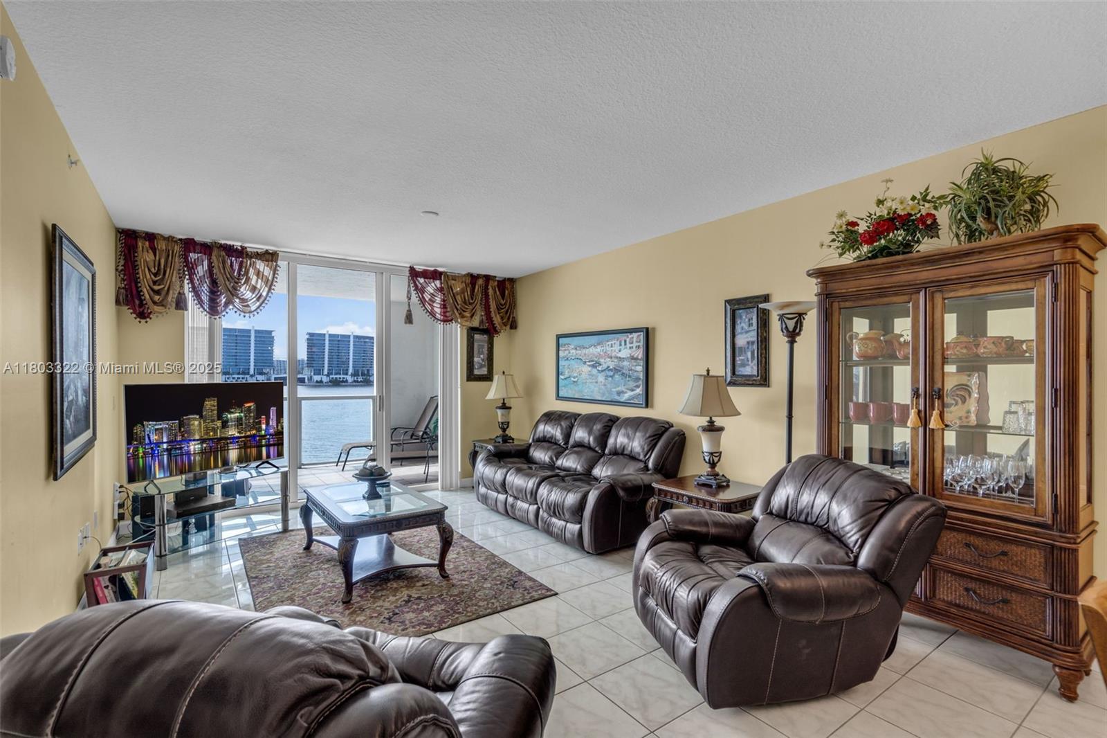 18100 North Bay Road, Unit 404 Sunny Isles Beach, FL 33160 - Photo 6 of 34 a living room with furniture a fireplace and a large window