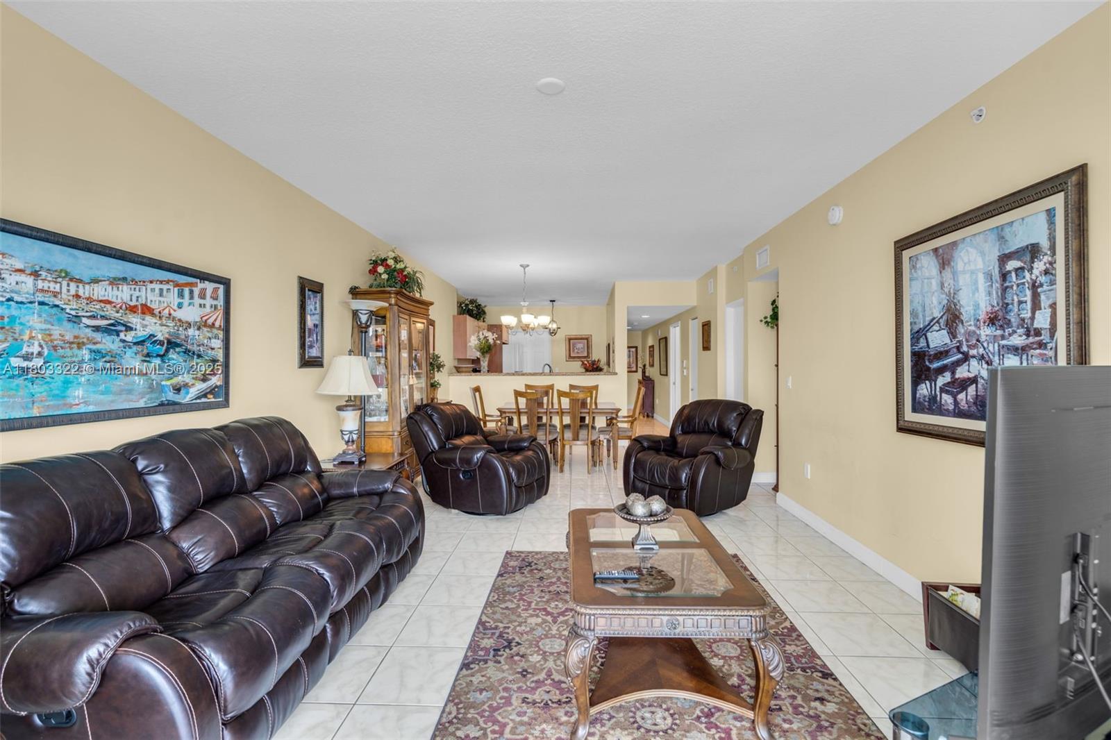 18100 North Bay Road, Unit 404 Sunny Isles Beach, FL 33160 - Photo 8 of 34 a living room with furniture ceiling fan and a rug